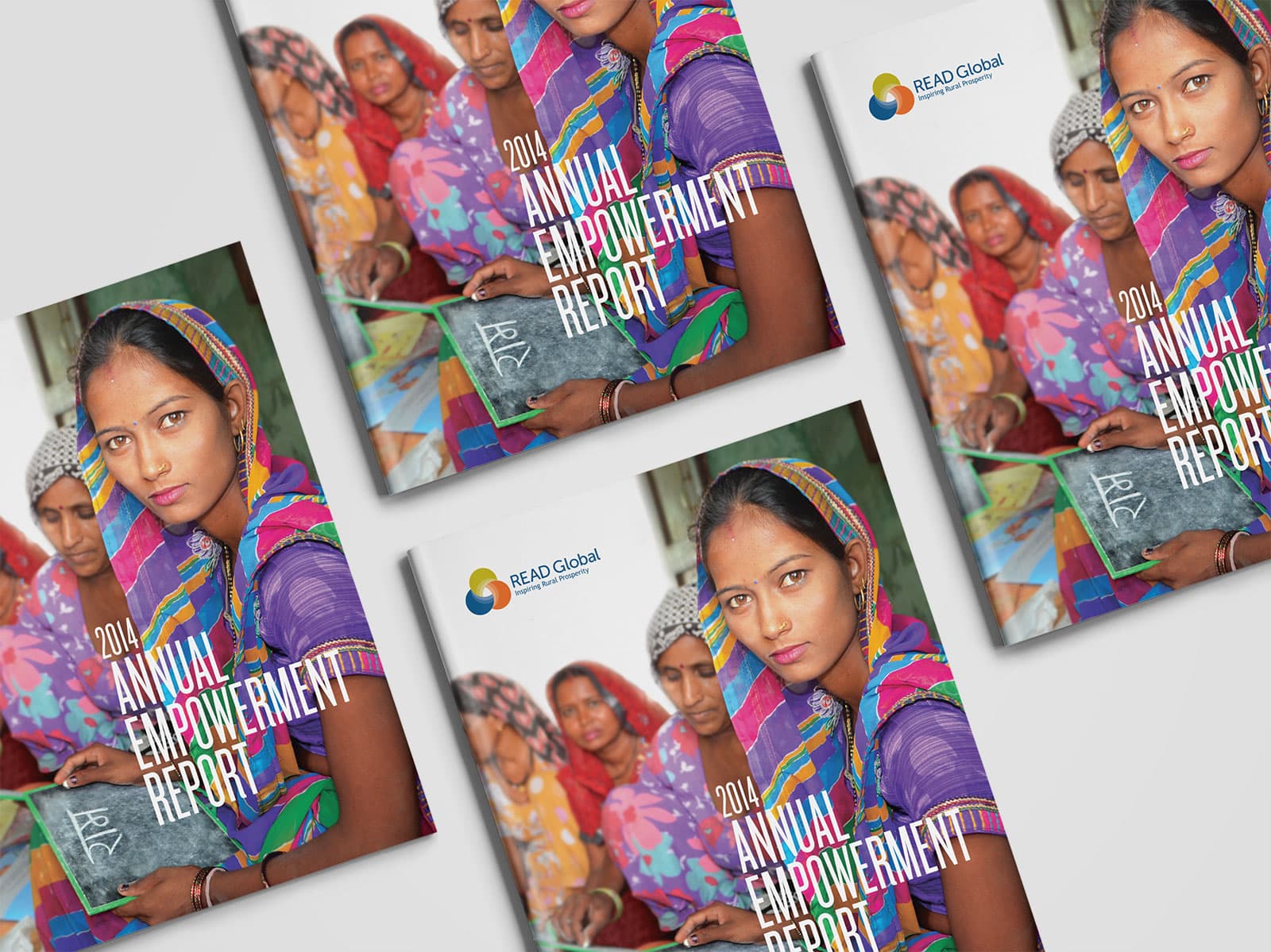 Photo of four copies of Read Global - 2014 Annual Empowerment Report